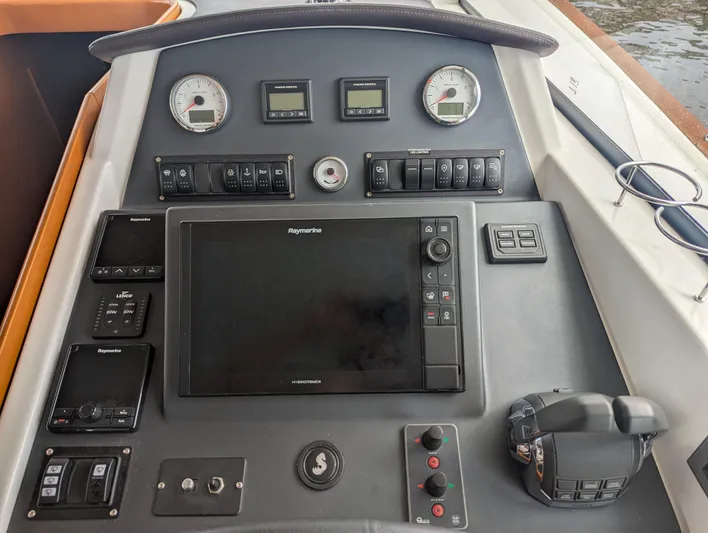  Yacht Photos Pics Control panel of a 2019 Beneteau Swift Trawler 44 with navigation and engine controls.