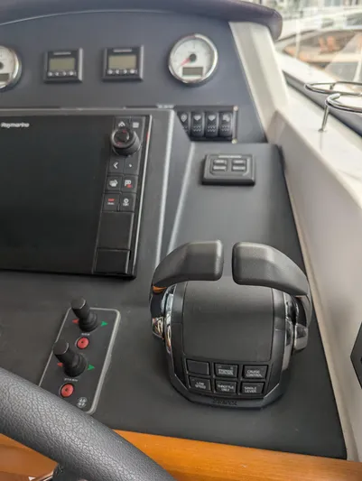  Yacht Photos Pics Control panel of 2019 Beneteau Swift Trawler 44 with navigation and throttle controls.