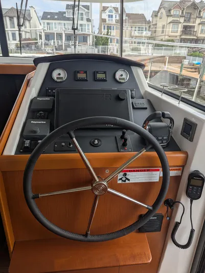  Yacht Photos Pics Helm of 2019 Beneteau Swift Trawler 44 with navigation controls and steering wheel.