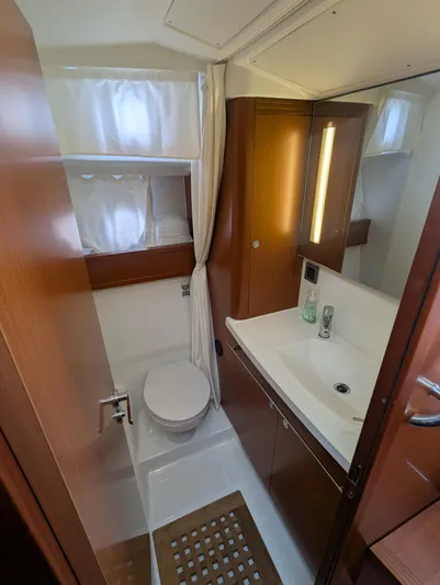  Yacht Photos Pics 2019 Beneteau Swift Trawler 44 bathroom with modern fixtures and wooden cabinetry.