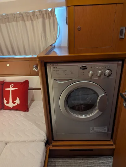  Yacht Photos Pics 2019 Beneteau Swift Trawler 44 interior with washing machine and nautical-themed decor.