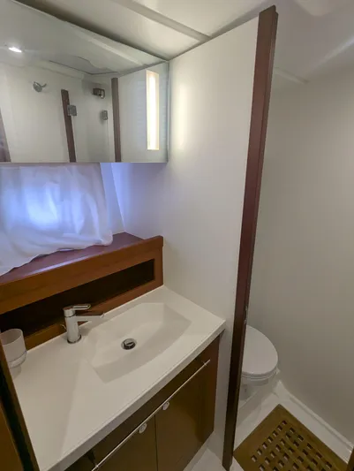  Yacht Photos Pics Bathroom interior of 2019 Beneteau Swift Trawler 44, featuring sink and toilet.