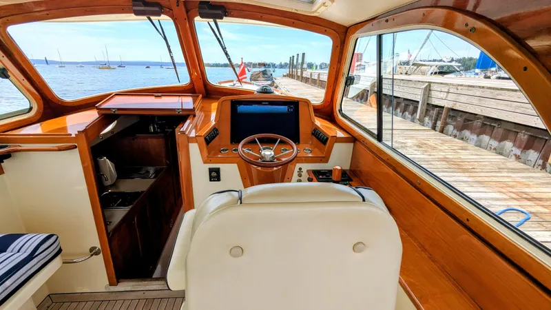 Luna Yacht Photos Pics Interior of a 2000 Hinckley Picnic Boat with wooden accents and a view of the dock.