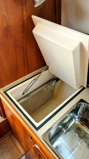 Luna Yacht Photos Pics Hinckley Picnic Boat 2000 interior with open storage compartment and stainless steel sink.