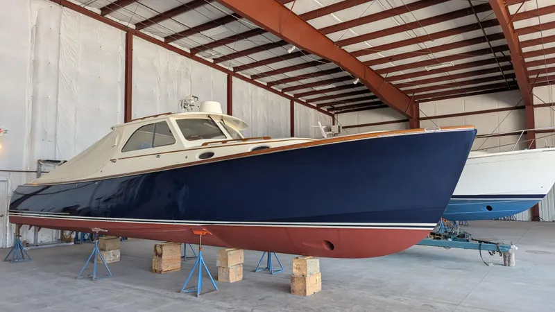 Luna Yacht Photos Pics 2000 Hinckley Picnic Boat in storage, blue hull, indoor warehouse setting.