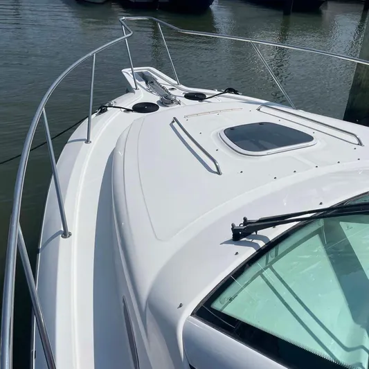 Reel Inspired Yacht Photos Pics 2009 Boston Whaler 345 Conquest boat deck, featuring sleek design and railing.