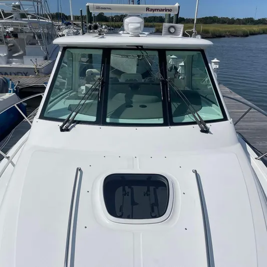 Reel Inspired Yacht Photos Pics 2009 Boston Whaler 345 Conquest boat docked, featuring sleek design and advanced navigation equipment.