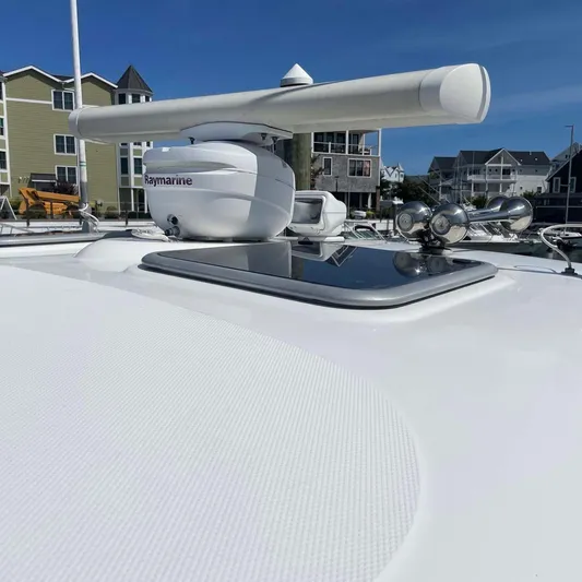 Reel Inspired Yacht Photos Pics 2009 Boston Whaler 345 Conquest radar system on deck, with coastal buildings in background.
