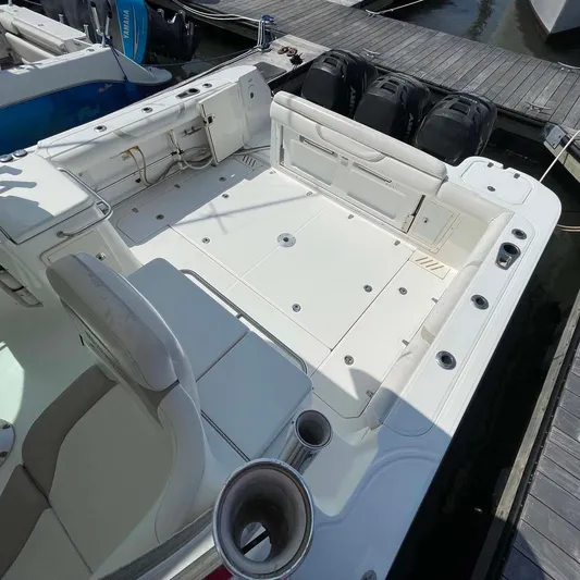 Reel Inspired Yacht Photos Pics 2009 Boston Whaler 345 Conquest boat deck with seating and triple outboard engines.