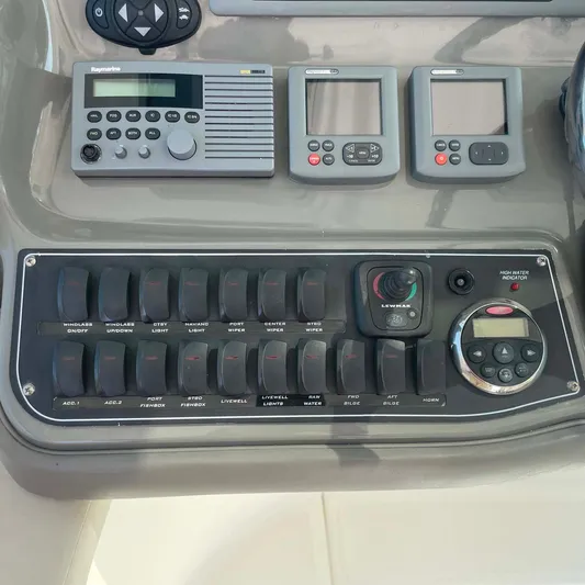 Reel Inspired Yacht Photos Pics Control panel of a 2009 Boston Whaler 345 Conquest boat with various switches and displays.