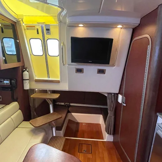 Reel Inspired Yacht Photos Pics Interior of 2009 Boston Whaler 345 Conquest with TV, stairs, and seating area.