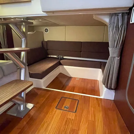 Reel Inspired Yacht Photos Pics Interior of 2009 Boston Whaler 345 Conquest with wood flooring and seating area.