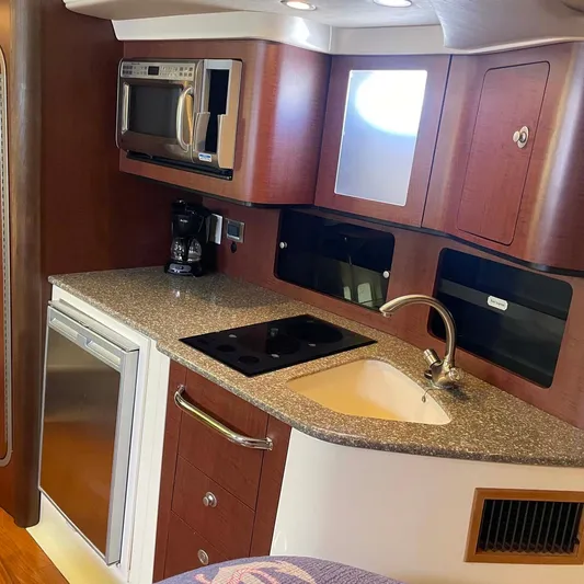 Reel Inspired Yacht Photos Pics 2009 Boston Whaler 345 Conquest kitchen with microwave, sink, and stove.