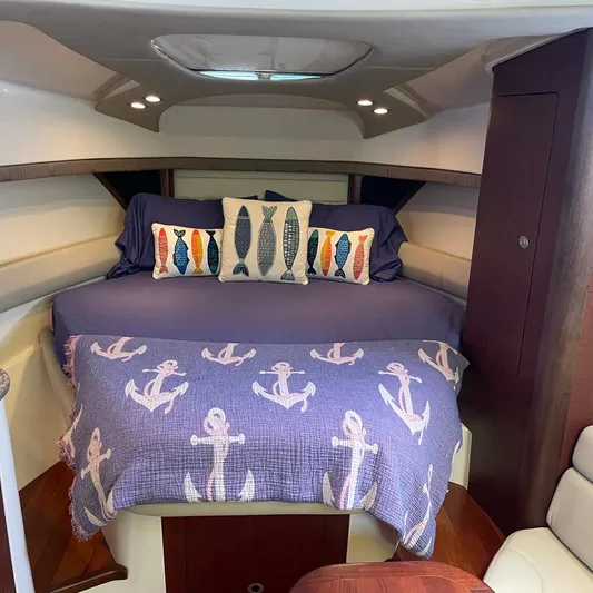Reel Inspired Yacht Photos Pics Cozy cabin interior of 2009 Boston Whaler 345 Conquest with nautical-themed bedding.