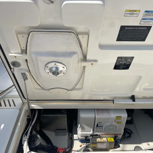 Reel Inspired Yacht Photos Pics Engine compartment of a 2009 Boston Whaler 345 Conquest boat, showing mechanical components.