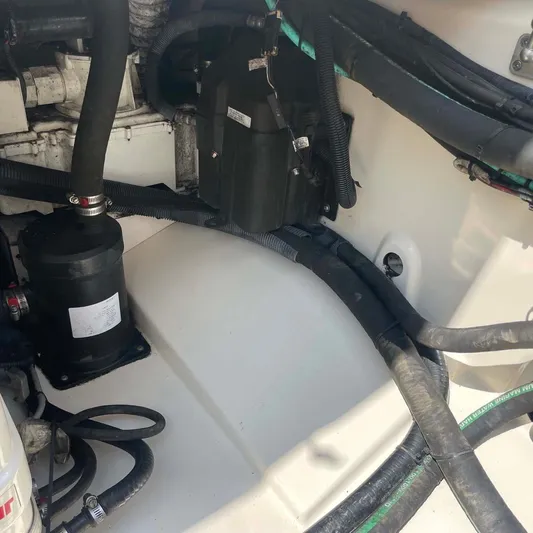 Reel Inspired Yacht Photos Pics Engine compartment of a 2009 Boston Whaler 345 Conquest with visible hoses and components.