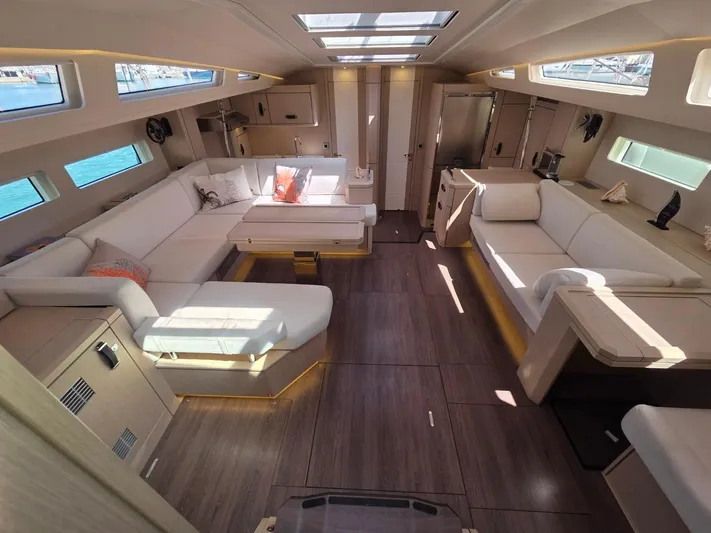 Yachting Conseil Yacht Photos Pics Luxurious interior of 2023 Jeanneau 60 yacht with elegant seating and modern design.