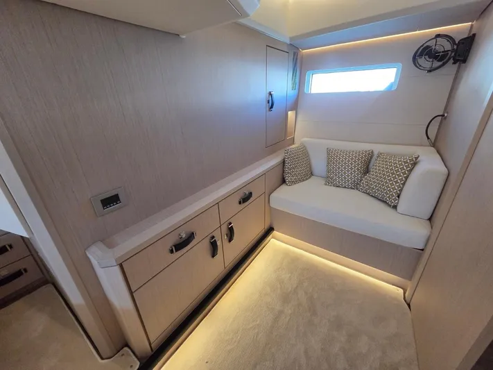 Yachting Conseil Yacht Photos Pics Luxurious interior of 2023 Jeanneau 60 yacht with cozy seating and elegant lighting.