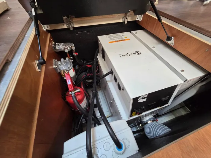 Yachting Conseil Yacht Photos Pics 2023 Jeanneau 60 engine compartment with fire extinguisher and electrical components.