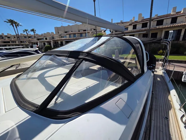 Yachting Conseil Yacht Photos Pics 2023 Jeanneau 60 yacht with sleek design, docked in a sunny marina setting.