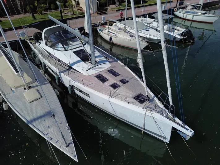 Yachting Conseil Yacht Photos Pics 2023 Jeanneau 60 yacht docked in marina, aerial view.