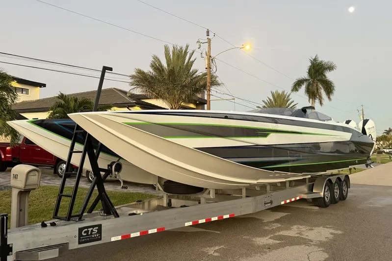  Yacht Photos Pics 2026 Nor-Tech 4000 Roadster powerboat on trailer, sleek design with green accents, parked roadside.