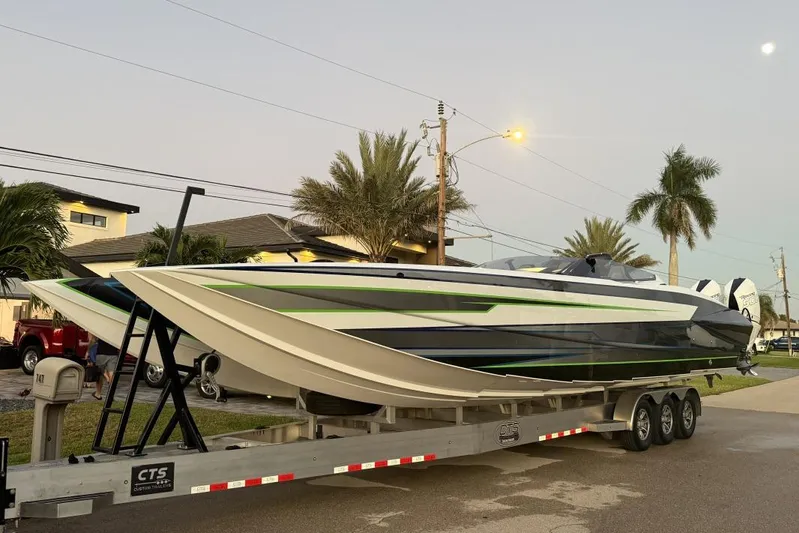  Yacht Photos Pics 2026 Nor-Tech 4000 Roadster powerboat on trailer, sleek design with green accents, parked roadside.