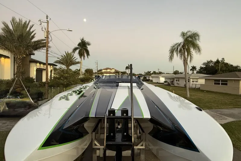  Yacht Photos Pics 2026 Nor-Tech 4000 Roadster boat in a tropical residential setting at sunset.