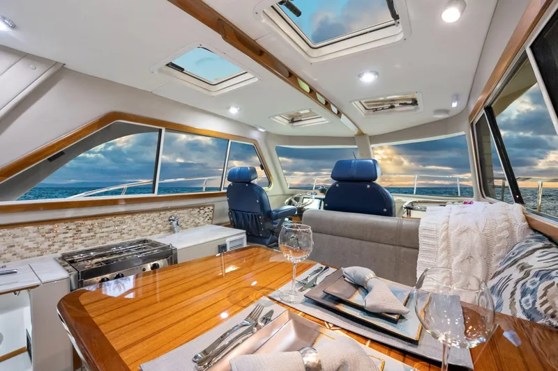  Yacht Photos Pics Luxurious interior of 2026 Aspen C100 yacht with elegant dining setup and ocean view.