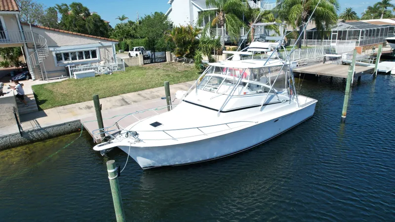 The Boo Factor Yacht Photos Pics 2003 Ocean 40 Super Sport yacht docked near waterfront homes.