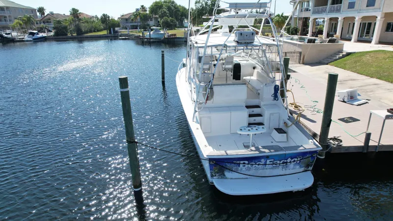 The Boo Factor Yacht Photos Pics 2003 Ocean 40 Super Sport yacht docked in a sunny marina.