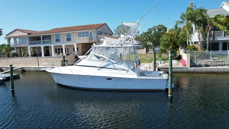 The Boo Factor Yacht Photos Pics 2003 Ocean 40 Super Sport yacht docked near waterfront homes.