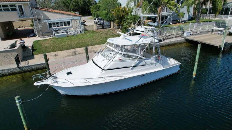 The Boo Factor Yacht Photos Pics 2003 Ocean 40 Super Sport yacht docked near waterfront home.