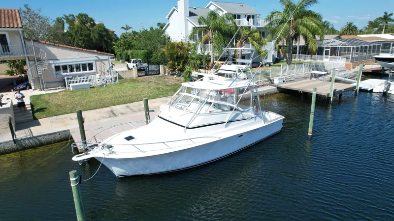 The Boo Factor Yacht Photos Pics 2003 Ocean 40 Super Sport yacht docked near waterfront homes.