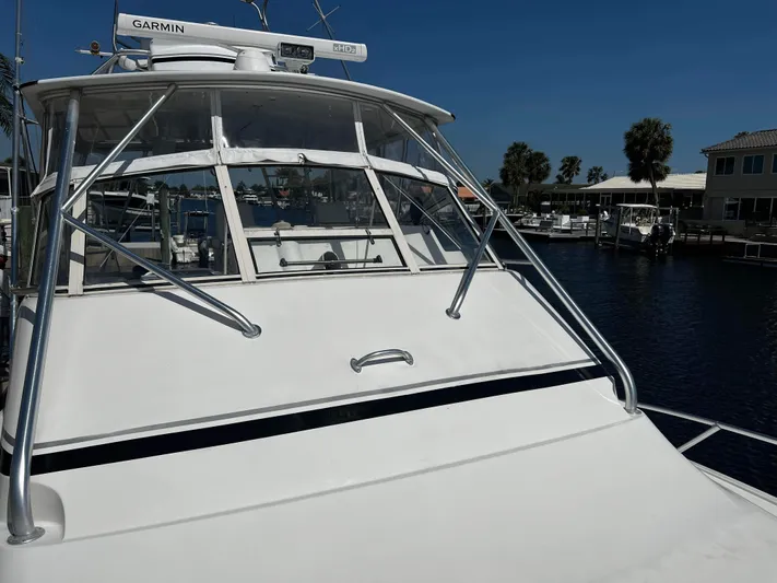 The Boo Factor Yacht Photos Pics 2003 Ocean 40 Super Sport yacht docked at marina under clear blue sky.