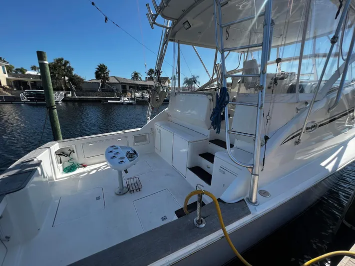 The Boo Factor Yacht Photos Pics 2003 Ocean 40 Super Sport yacht docked, featuring spacious deck and fishing equipment.