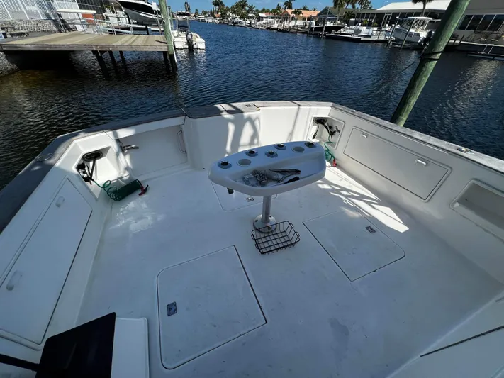 The Boo Factor Yacht Photos Pics 2003 Ocean 40 Super Sport boat deck with fishing station, docked at marina.