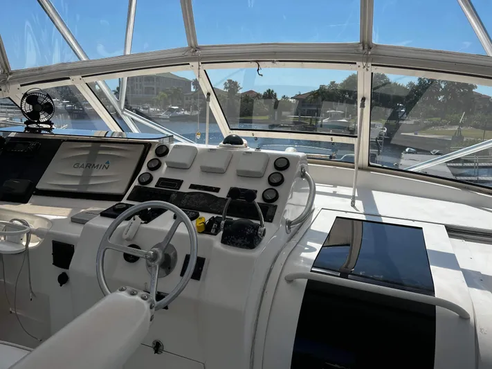 The Boo Factor Yacht Photos Pics 2003 Ocean 40 Super Sport yacht helm with Garmin navigation system and marina view.