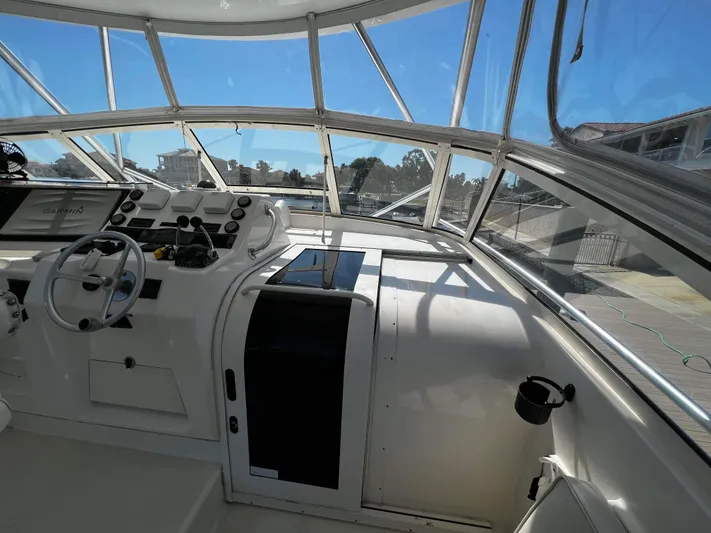 The Boo Factor Yacht Photos Pics 2003 Ocean 40 Super Sport boat cockpit with steering wheel and navigation equipment.