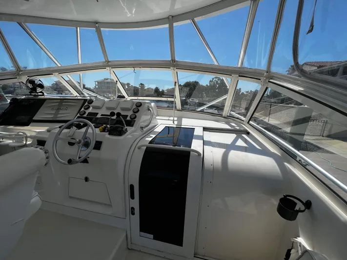 The Boo Factor Yacht Photos Pics 2003 Ocean 40 Super Sport yacht cockpit with steering wheel and navigation equipment.