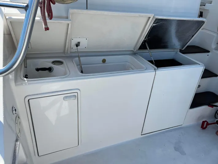 The Boo Factor Yacht Photos Pics 2003 Ocean 40 Super Sport yacht interior with open storage compartments and steps.