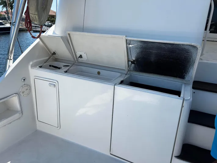 The Boo Factor Yacht Photos Pics 2003 Ocean 40 Super Sport yacht with open storage compartments on deck.