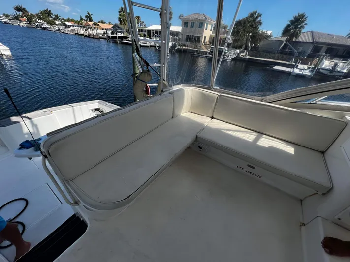 The Boo Factor Yacht Photos Pics 2003 Ocean 40 Super Sport boat interior with seating, docked by waterfront homes.
