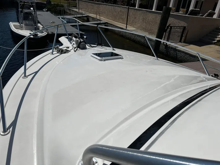 The Boo Factor Yacht Photos Pics 2003 Ocean 40 Super Sport yacht deck, docked near waterfront homes.