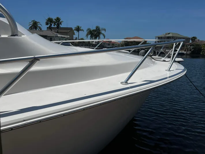 The Boo Factor Yacht Photos Pics 2003 Ocean 40 Super Sport yacht docked on calm water, sunny day.