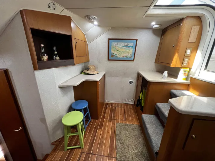 The Boo Factor Yacht Photos Pics Interior of 2003 Ocean 40 Super Sport yacht with wooden flooring and bar stools.