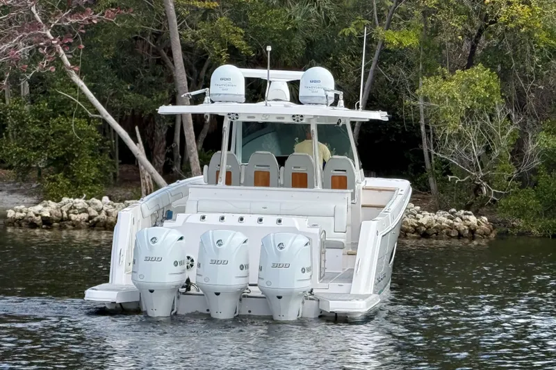  Yacht Photos Pics 2020 Regal 38 SAV boat with triple Yamaha 300 engines on a calm waterway.