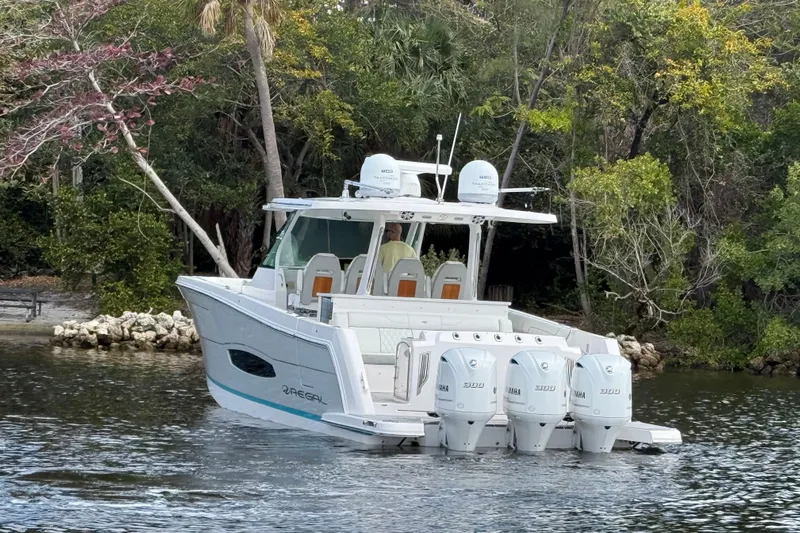  Yacht Photos Pics 2020 Regal 38 SAV boat with four engines on a serene waterway.
