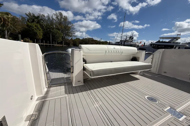  Yacht Photos Pics 2020 Regal 38 SAV boat deck with seating, docked under a blue sky.