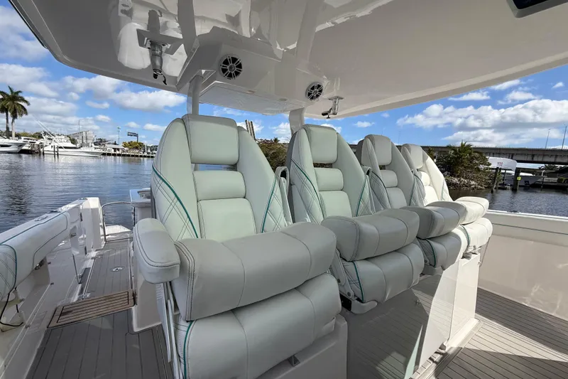  Yacht Photos Pics Luxurious seating on 2020 Regal 38 SAV boat, docked by a scenic waterfront.